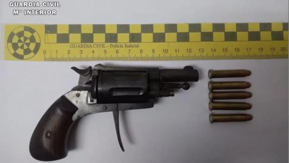 revólver sin marcas ni numeración visible, alojando en el interior del cilindro 5 proyectiles municionados.