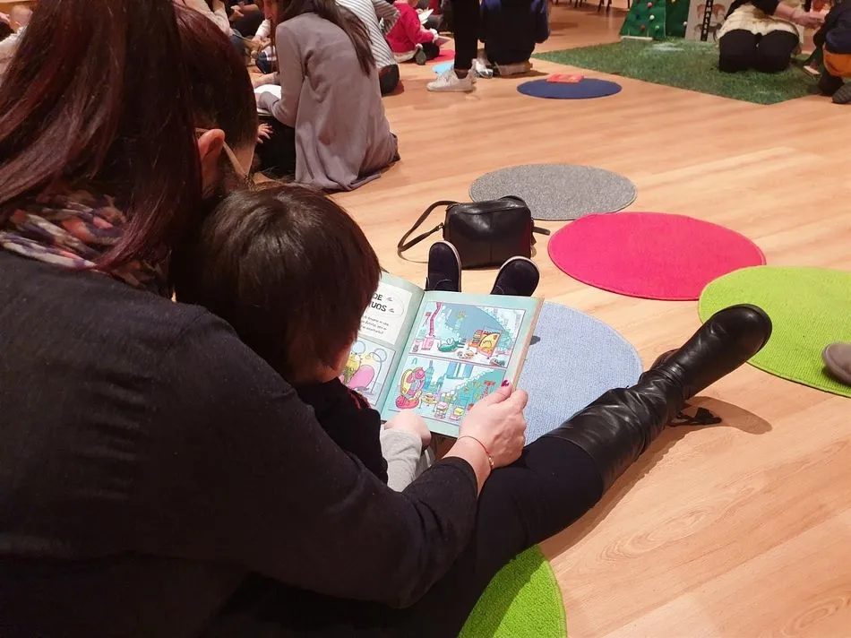 Una madre y su hijo leen un libro en una propuesta de fomento de la lectura en Salamanca. - EUROPA PRESS