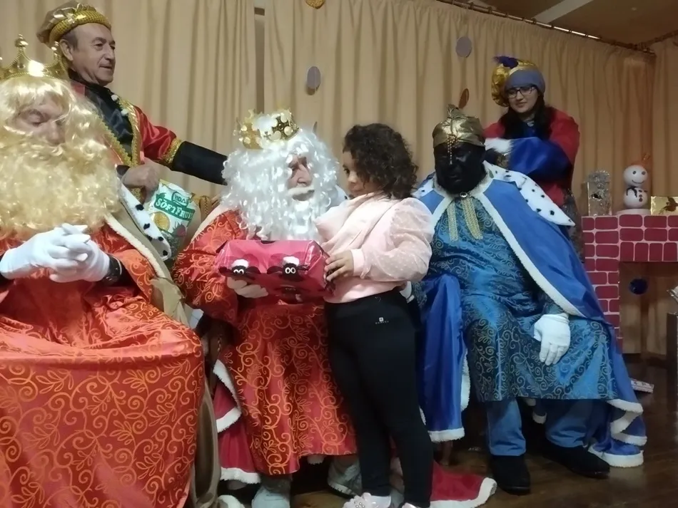 Melchor entrega un regalo a una niña | Elena del Carmen Prieto
