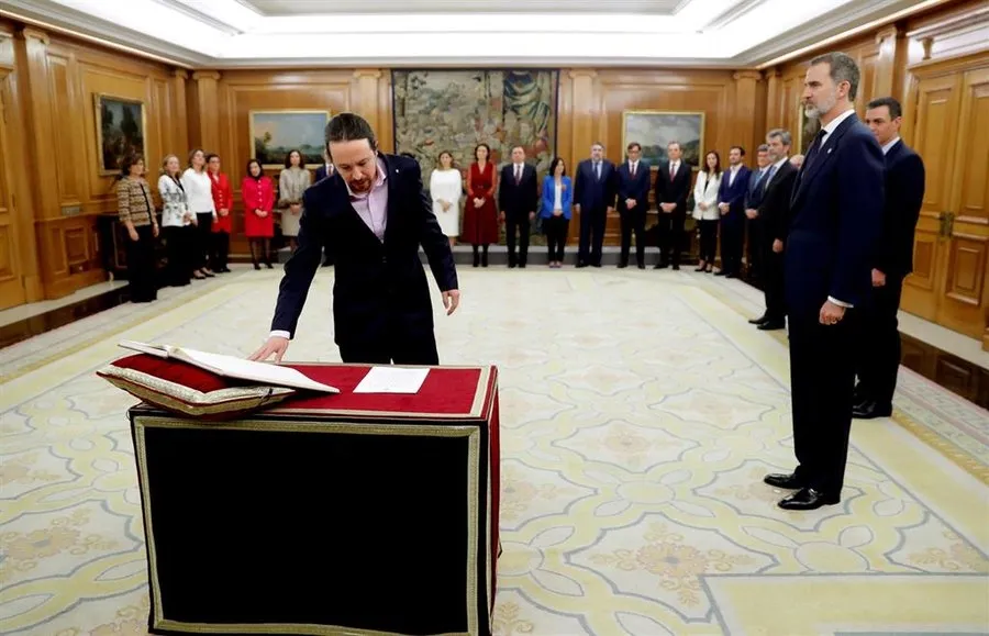 Iglesias y Garzón prometen su cargo con un pin del triángulo rojo invertido, que simboliza la...