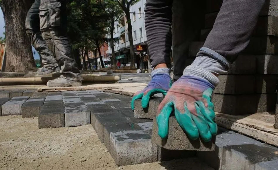 Un trabajador renovando el pavimento del suelo en una obra