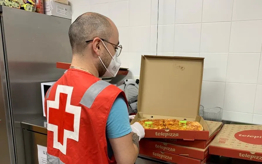 Uno de los voluntarios de Cruz Roja Salamanca preparando un pedido donado por Telepizza para el Centro de Personas Sin Hogar