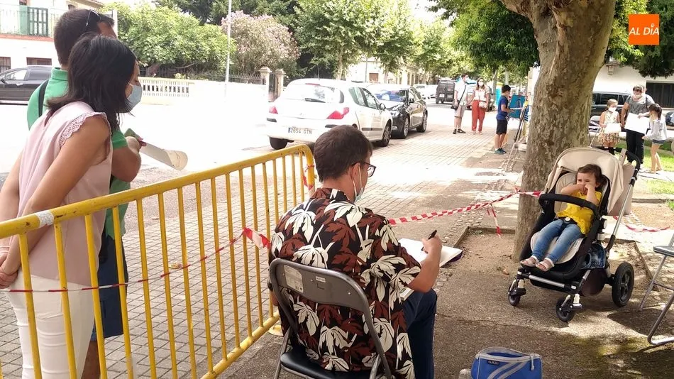 Una niña posa ante el artista que plasmó su imagen en una caricatura / E. Corredera