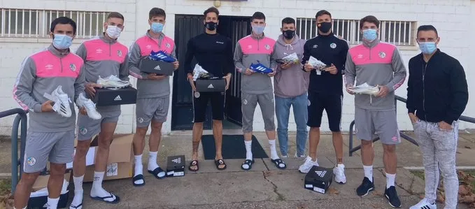 Piojo (a la derecha), junto a los jugadores del Salamanca, a la puerta de los vestuarios del Helmántico