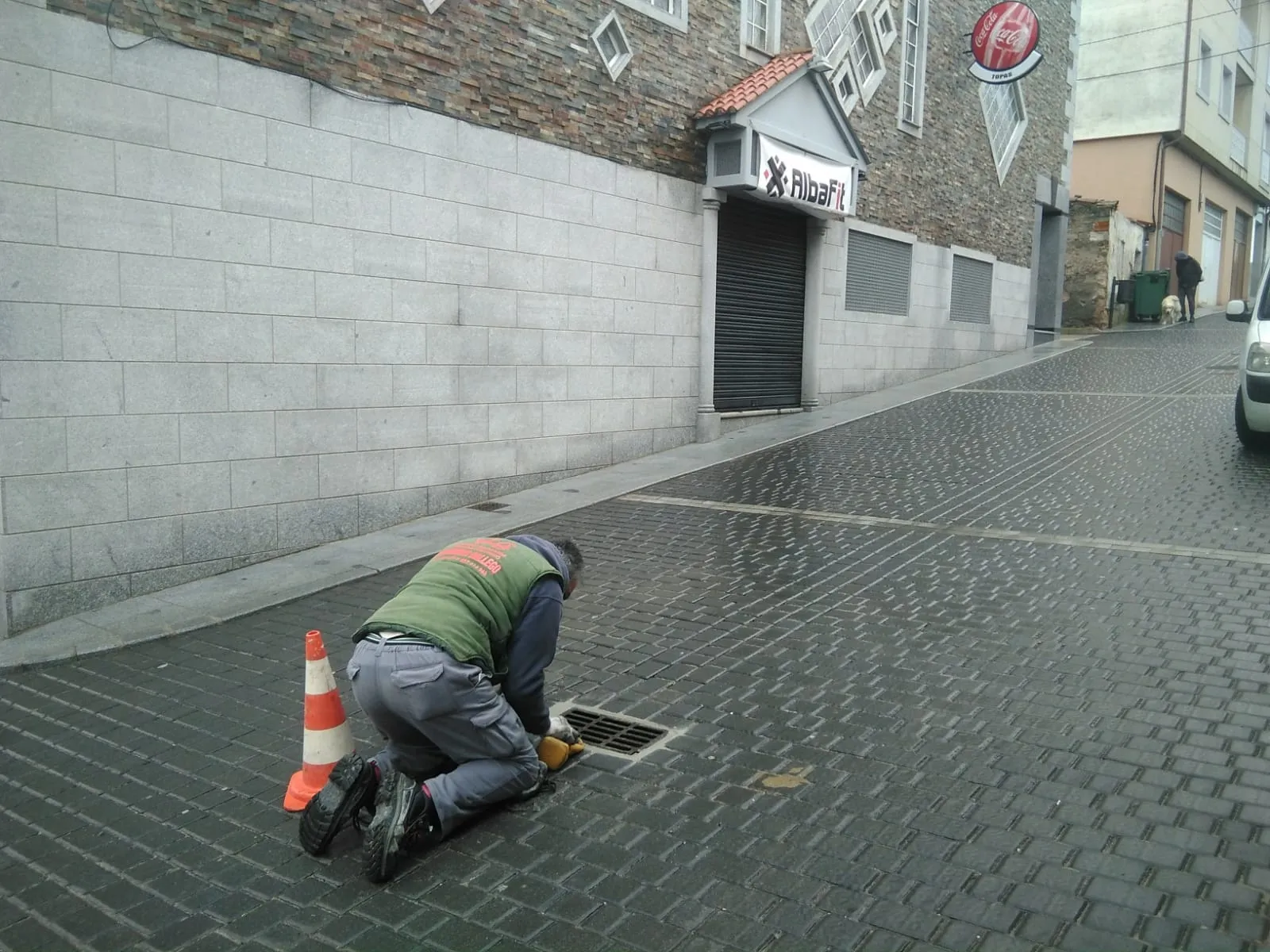 Un operario municipal realiza una reparación en una alcantarilla