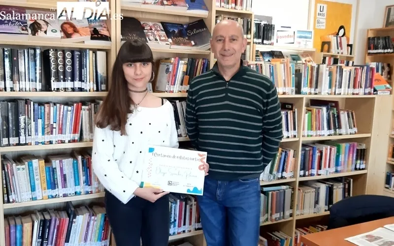 Olaya Sánchez Raizová recibía el diploma como ganadora de manos de Esteban Javier Martin Cuadrado, técnico de la Biblioteca de Ledesma 