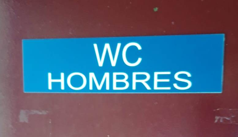 Un usuario coloca rótulos para acabar con las confusiones en los aseos-vestuarios de El Picón
