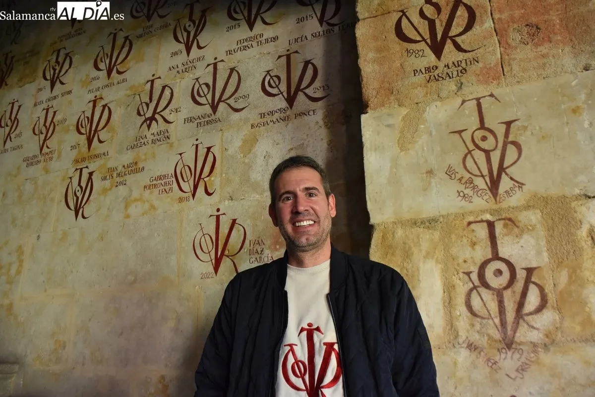 Miguel García, pintor de vítores en la USAL junto a algunas de sus obras | FOTOS: V. Martins 
